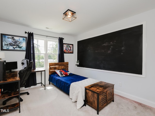 bedroom with carpet floors, a desk, and baseboards