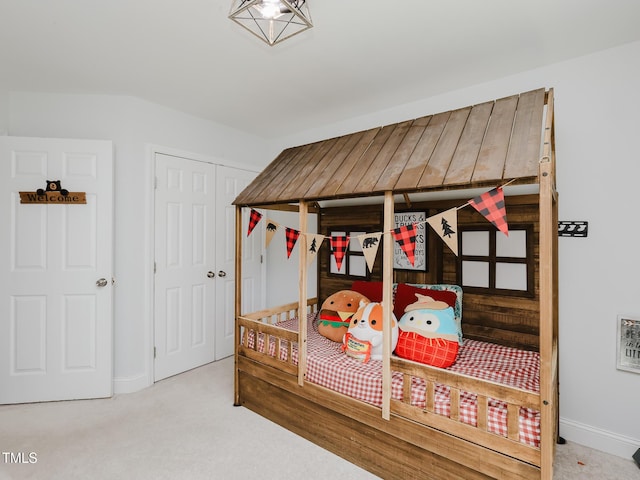 bedroom with carpet floors, baseboards, and a closet