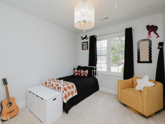 bedroom featuring light colored carpet and baseboards