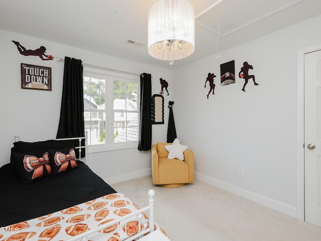 carpeted bedroom featuring attic access and baseboards