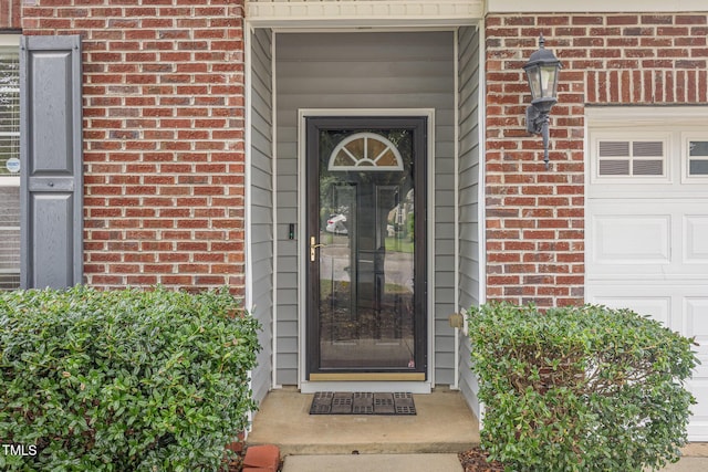 12340 Tetons Ct, Durham, NC 27703 - doorway to property featuring brick siding and an attached garage