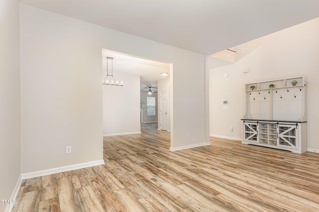 12340 Tetons Ct, Durham, NC 27703 - spare room with wood finished floors, a ceiling fan, and a chandelier