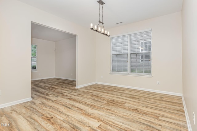 12340 Tetons Ct, Durham, NC 27703 - spare room featuring a chandelier and light wood-type flooring