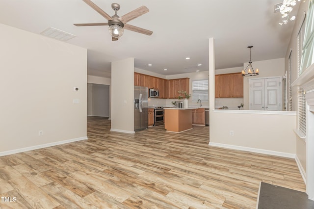 12340 Tetons Ct, Durham, NC 27703 - unfurnished living room with ceiling fan, light wood finished floors, recessed lighting, and a chandelier