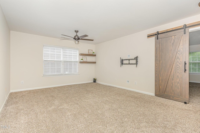 12340 Tetons Ct, Durham, NC 27703 - spare room with carpet, a ceiling fan, and a barn door