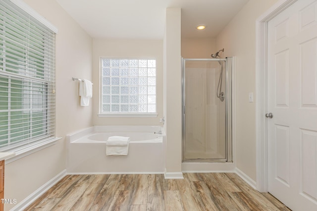 12340 Tetons Ct, Durham, NC 27703 - full bath with a garden tub, a shower stall, wood finished floors, and recessed lighting