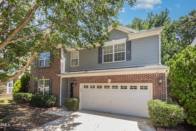 12340 Tetons Ct, Durham, NC 27703 - traditional home featuring concrete driveway, an attached garage, and brick siding