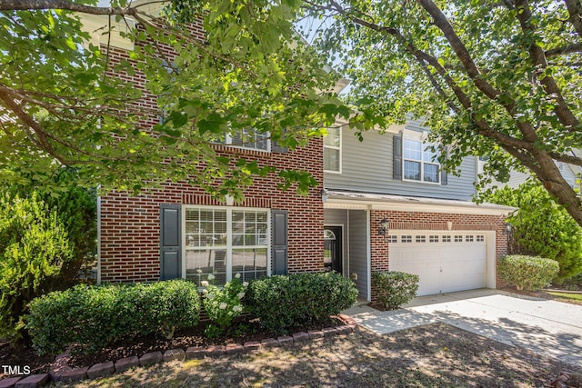 12340 Tetons Ct, Durham, NC 27703 - view of front facade with brick siding, driveway, and an attached garage