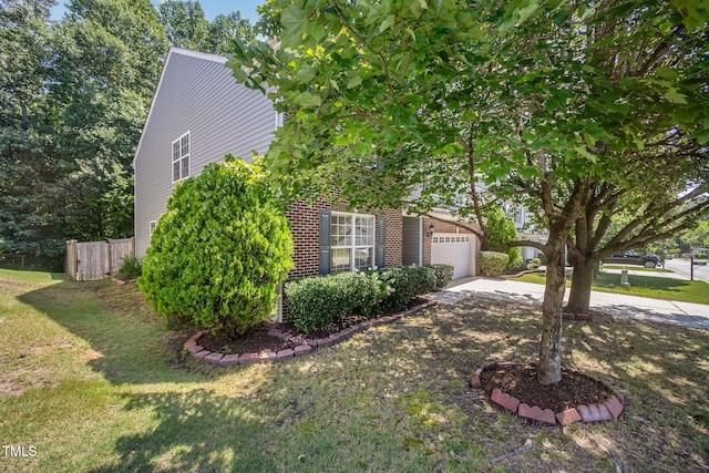 12340 Tetons Ct, Durham, NC 27703 - view of side of property featuring driveway, brick siding, and a garage