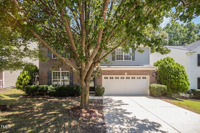 12340 Tetons Ct, Durham, NC 27703 - view of front of home featuring brick siding, a garage, and concrete driveway