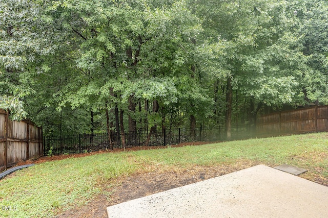 12340 Tetons Ct, Durham, NC 27703 - fenced backyard featuring a patio area