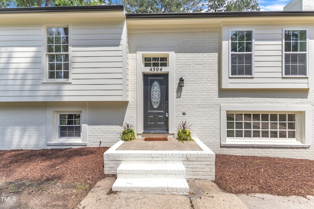 doorway to property with brick siding
