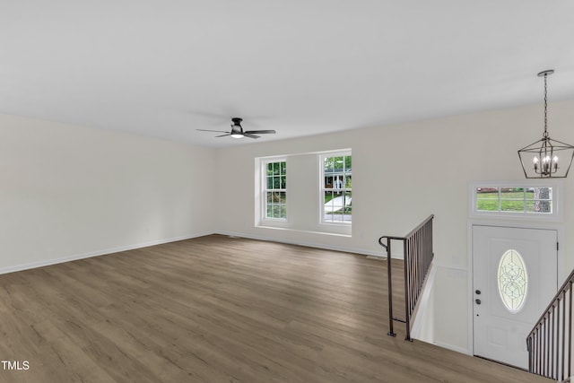 entrance foyer with a chandelier, healthy amount of natural light, wood finished floors, and ceiling fan