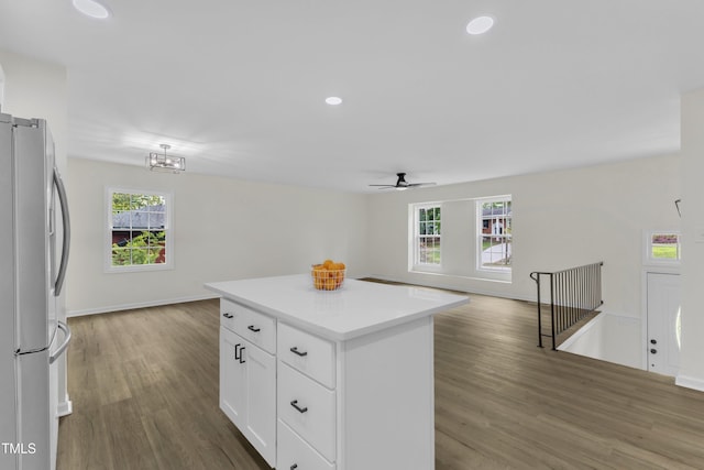kitchen featuring freestanding refrigerator, open floor plan, wood finished floors, healthy amount of natural light, and recessed lighting