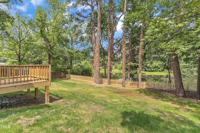 view of yard with a deck and view of scattered trees