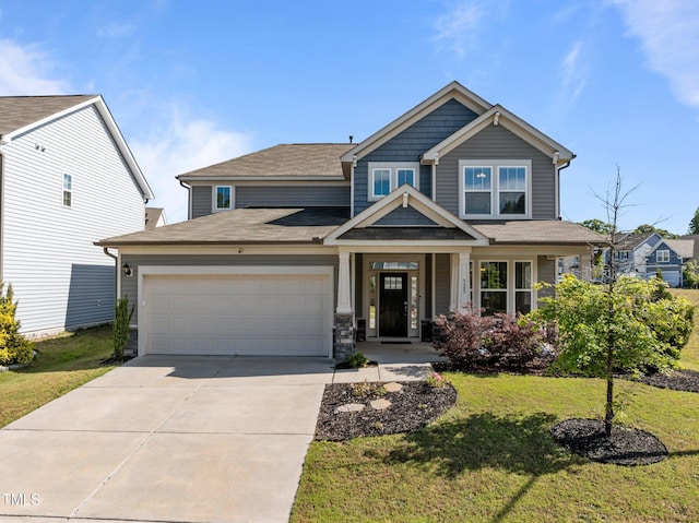 craftsman-style house featuring concrete driveway, an attached garage, and a front yard