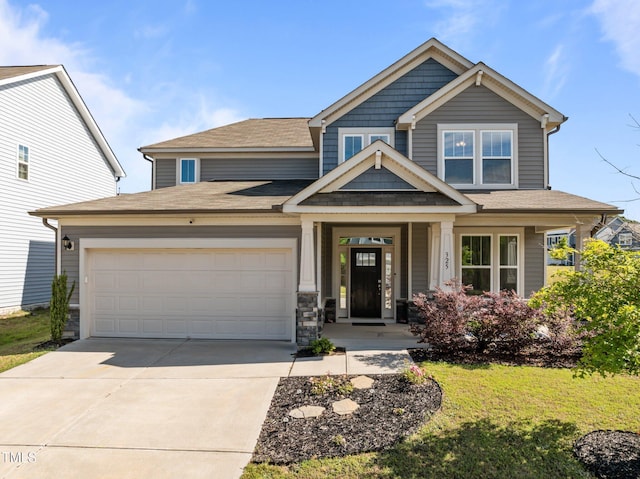 view of front of property with driveway, an attached garage, a front lawn, a shingled roof, and covered porch