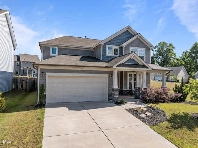 craftsman inspired home featuring covered porch, an attached garage, concrete driveway, and a shingled roof