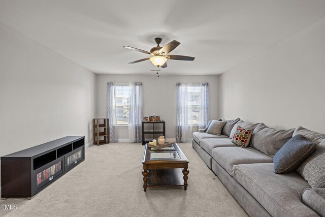 living area featuring ceiling fan, carpet, and baseboards