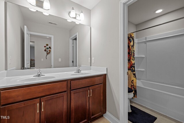 full bath with toilet, double vanity, and shower / tub combo with curtain