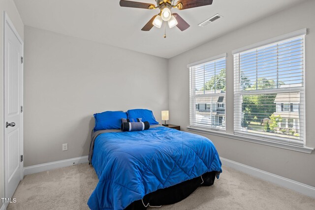 bedroom with baseboards, carpet floors, and ceiling fan
