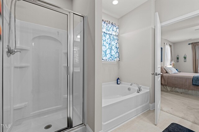 ensuite bathroom featuring a stall shower, plenty of natural light, and a bath