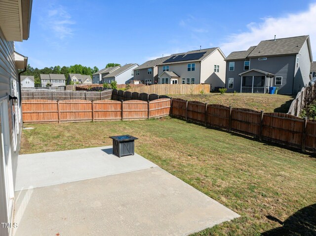 view of yard with a residential view and a patio area