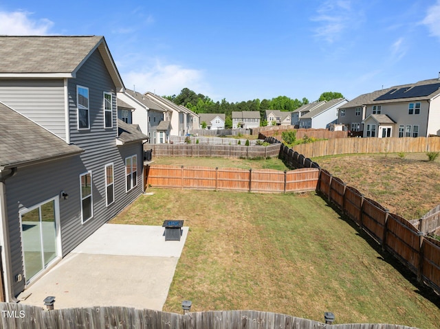 view of yard with a residential view and a patio area