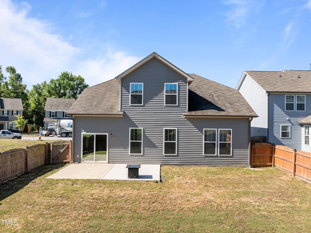 rear view of house with a patio and a shingled roof