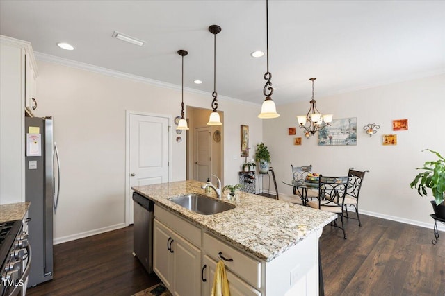 kitchen with a sink, stainless steel appliances, dark wood finished floors, ornamental molding, and baseboards