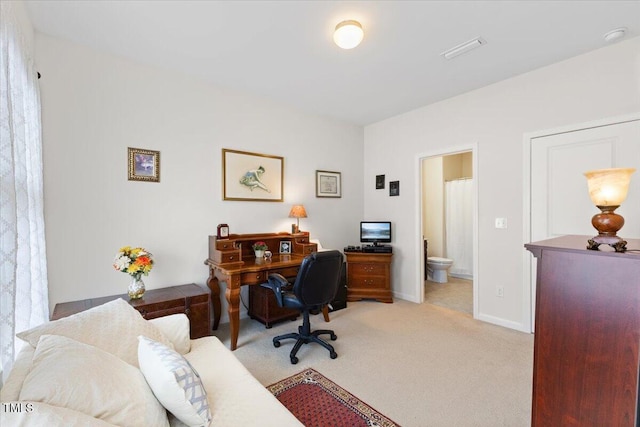 office with light colored carpet and baseboards