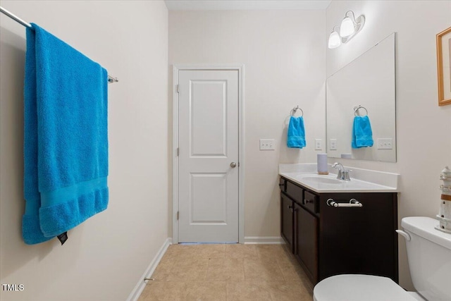bathroom with vanity, toilet, baseboards, and tile patterned floors