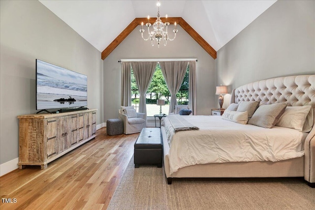 bedroom featuring a chandelier, high vaulted ceiling, light wood finished floors, and baseboards