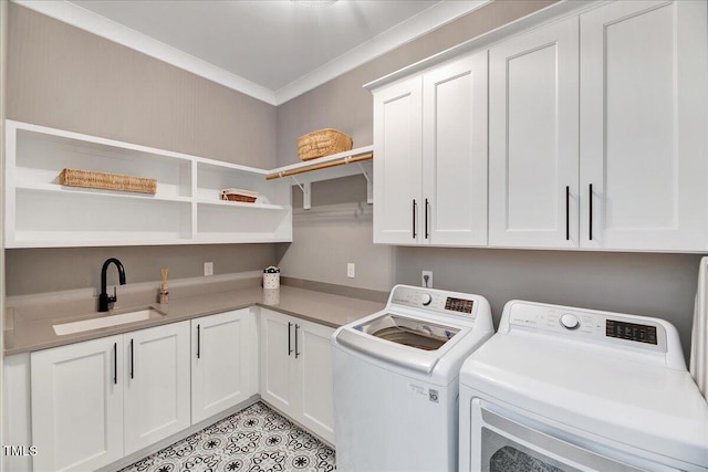 washroom with cabinet space, washer and clothes dryer, and crown molding