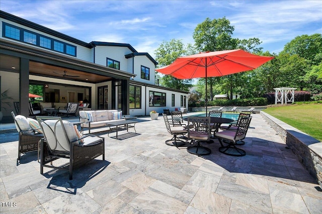 view of patio featuring outdoor lounge area, an outdoor pool, a ceiling fan, and outdoor dining area