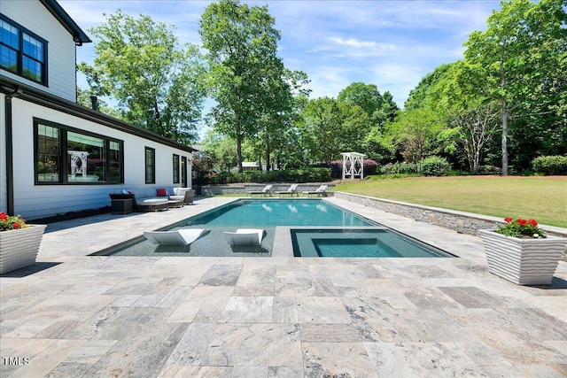 outdoor pool with a lawn, a patio area, and an in-ground hot tub