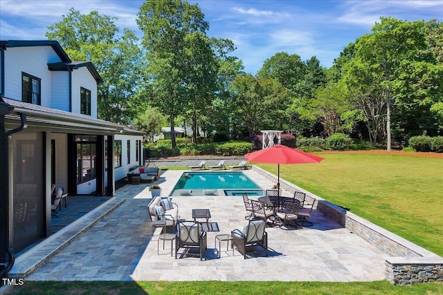 outdoor pool with a lawn, a patio, and an outdoor hangout area