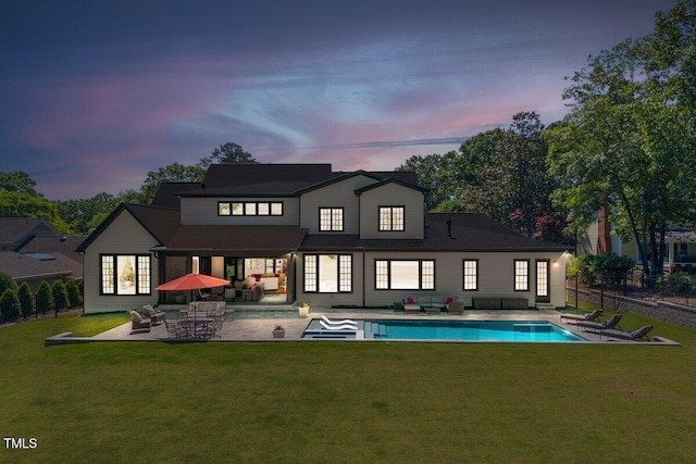 back of house featuring outdoor lounge area and a patio