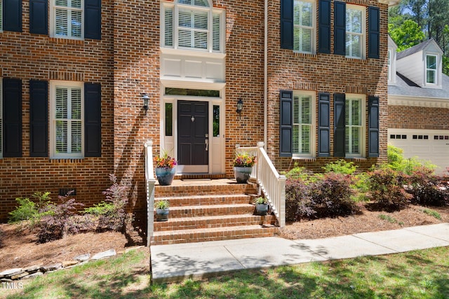 property entrance featuring brick siding