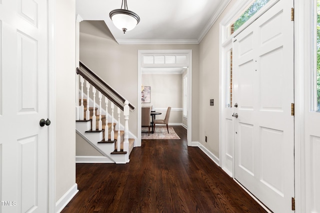 foyer entrance featuring wood finished floors, stairway, baseboards, and crown molding