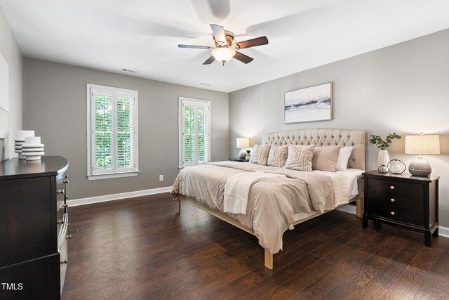 bedroom with dark wood-style flooring, baseboards, and a ceiling fan