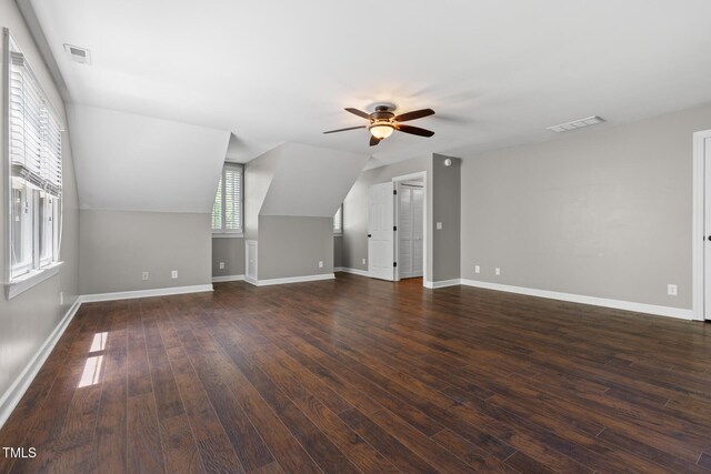 additional living space featuring ceiling fan, baseboards, wood finished floors, and vaulted ceiling