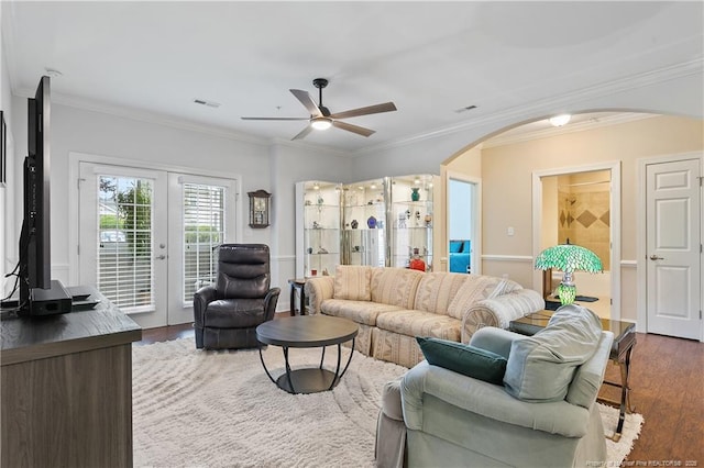 living room featuring wood finished floors, french doors, visible vents, ceiling fan, and arched walkways