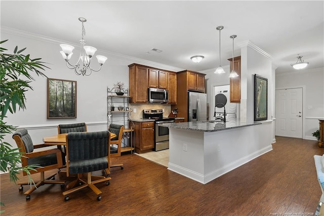 kitchen featuring stainless steel appliances, brown cabinetry, wood finished floors, crown molding, and decorative backsplash