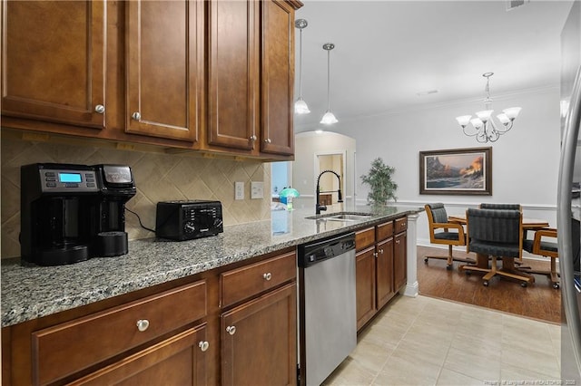 kitchen with a sink, light stone countertops, dishwasher, tasteful backsplash, and ornamental molding