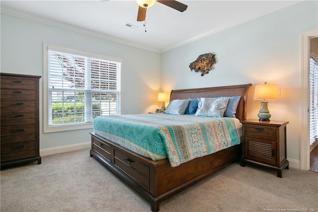 carpeted bedroom with baseboards, crown molding, visible vents, and a ceiling fan