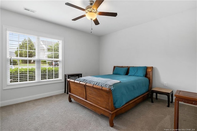 carpeted bedroom with baseboards, ceiling fan, and visible vents