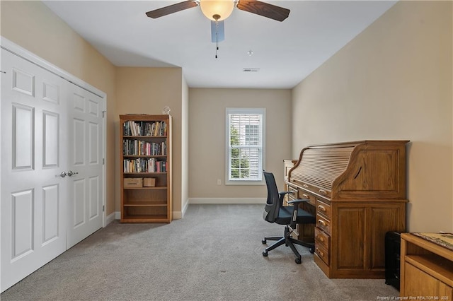 carpeted office space with visible vents, baseboards, and ceiling fan