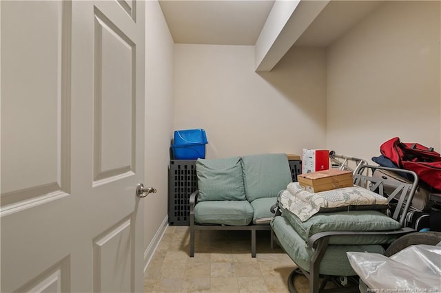 living area featuring baseboards