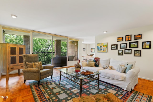 living area featuring baseboards and expansive windows
